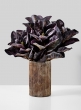 purple magnolia arrangement in vintage look glass vase